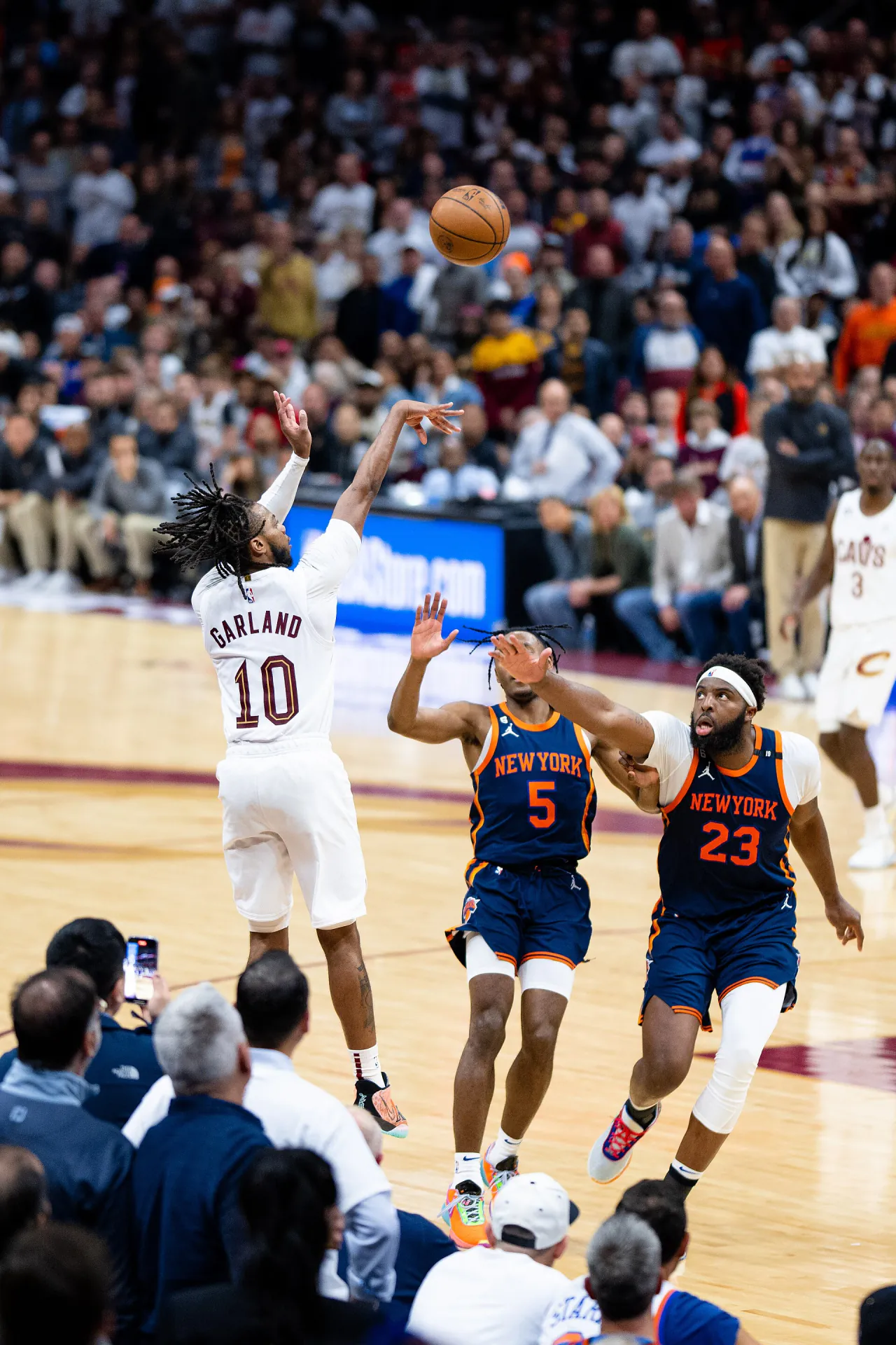 Mitchell Robinson 身穿紐約尼克深藍色 23 號球衣，2023 年 4 月季後賽作客克里夫蘭騎士時伸手封阻 Darius Garland 的跳投（攝影 Erik Drost，授權 CC BY 2.0，來源 Wikimedia Commons）